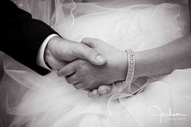 couple holding hands with ornate bracelet