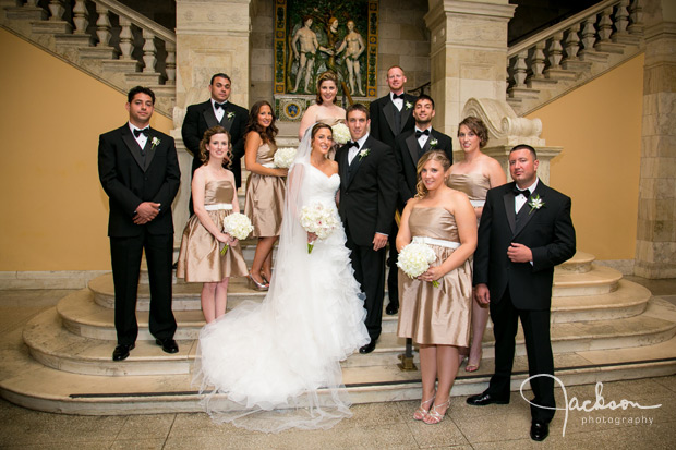 wedding party on staircase of musuem