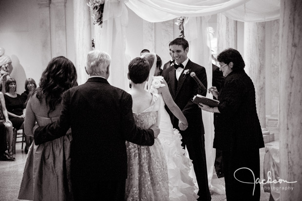 father hugging daughter and wife at ceremony