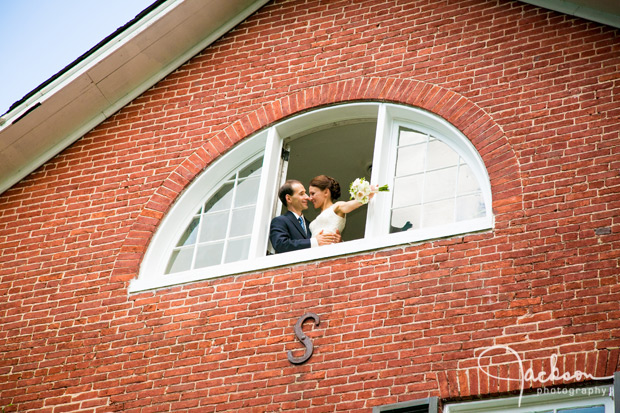 bride and groom in upstairs open window