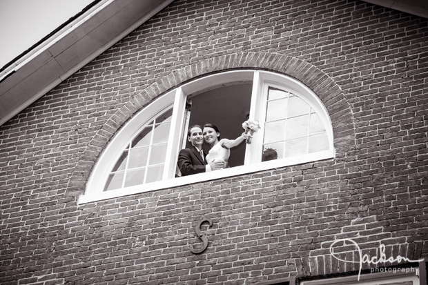 bride and groom embracing in window