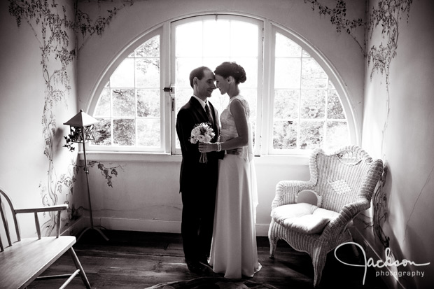 bride and groom by upstairs garden window
