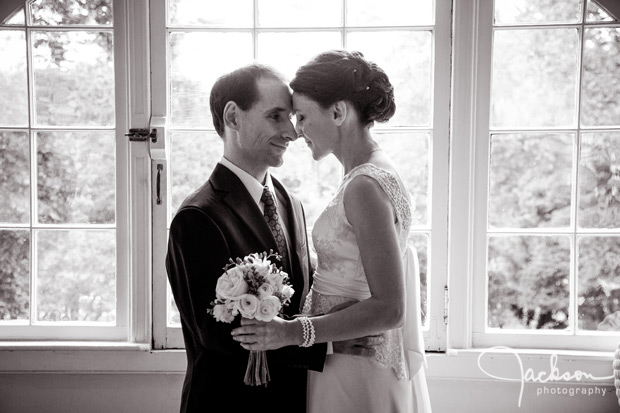 bride and groom by window close