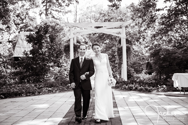 bride and groom walking down the aisle smiling