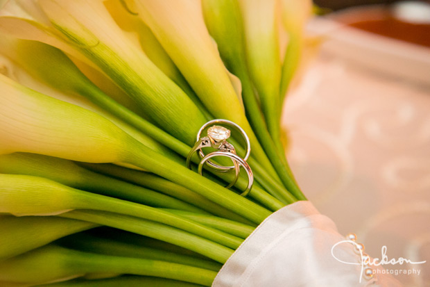 wedding rings among stems of bride bouquet