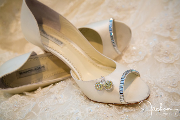 bride's cream colored heels and diamond earrings