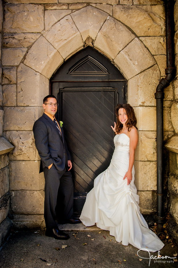 bride and groom in stone doorway