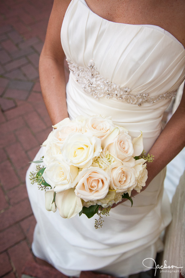 bride holding white rose bouquet