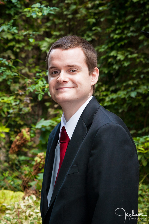 groom with red tie and boutonniere