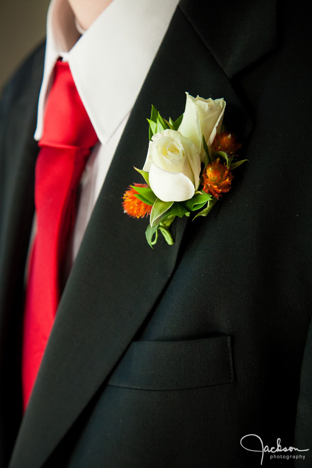 red tie ivory rose boutonniere
