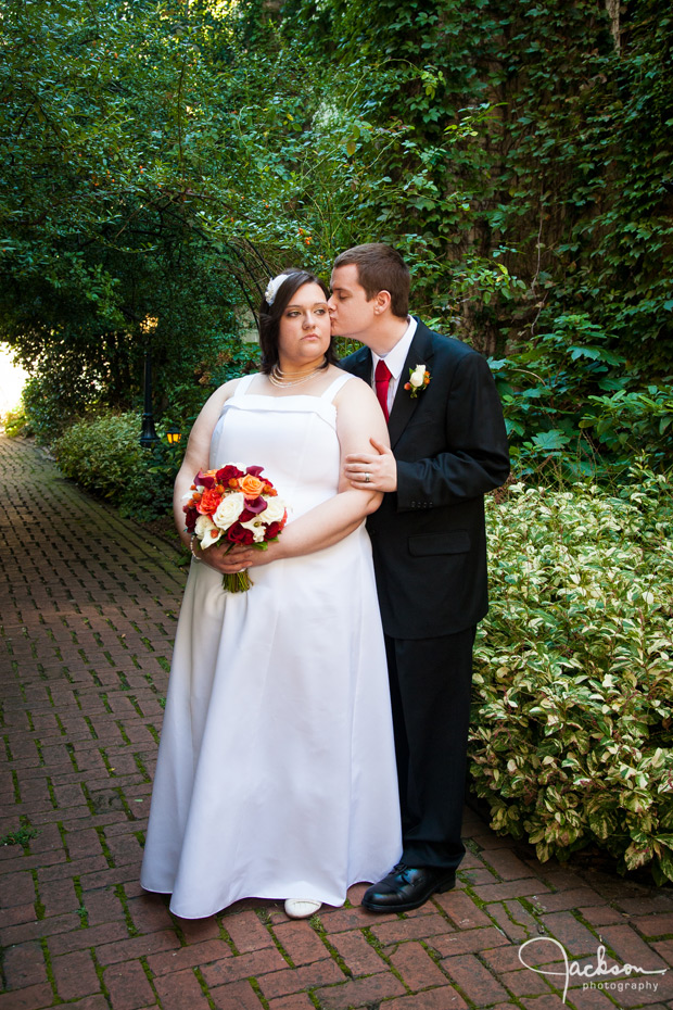 groom kissing bride on cheek