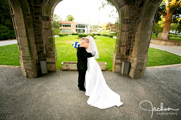 bride and groom embracing in front of maryvale castle