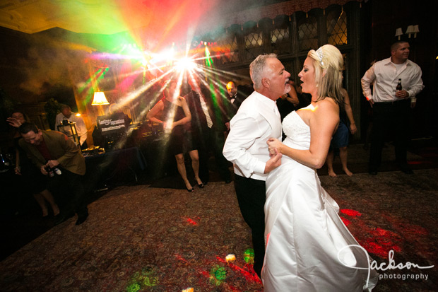 bride and groom dancing with colored lights
