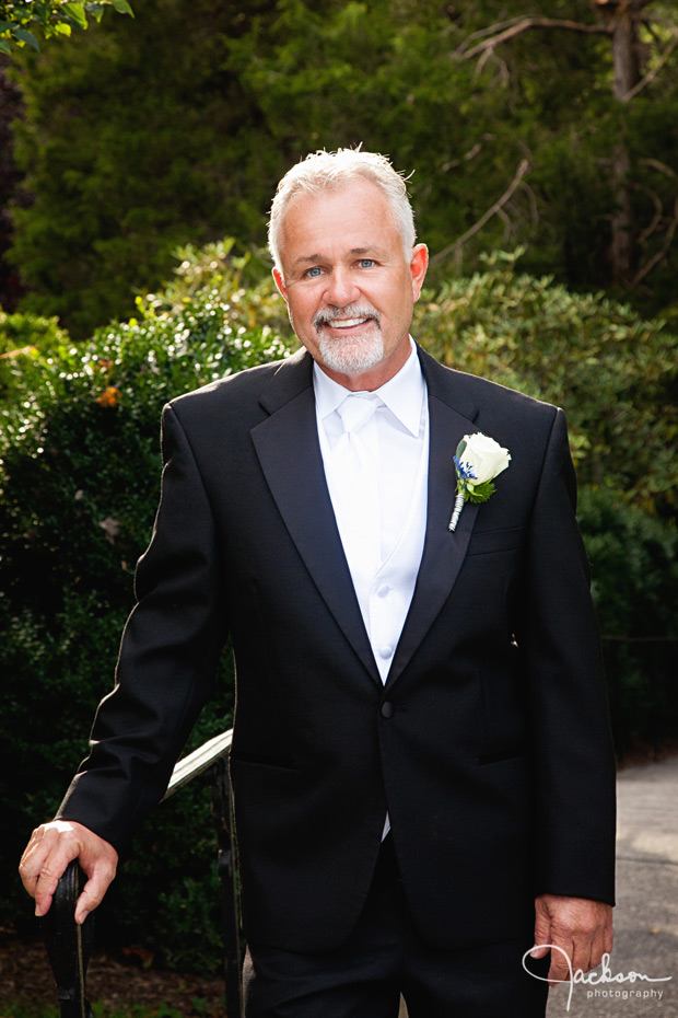 groom leaning on railing