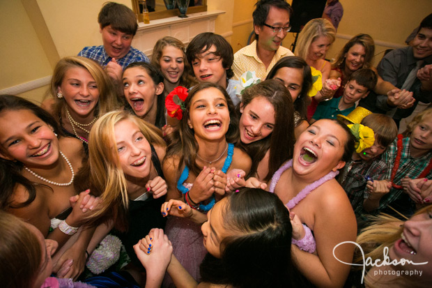 mitzvah girl surrounded by friends at party