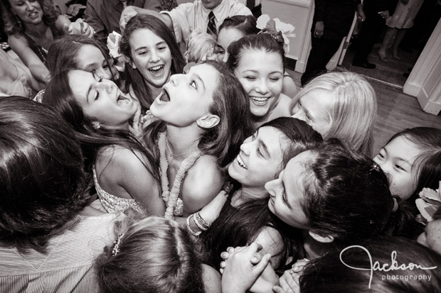 mitzvah girl surrounded by friends at party