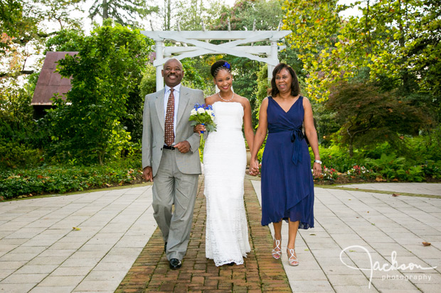 mother and father walking bride down aisle