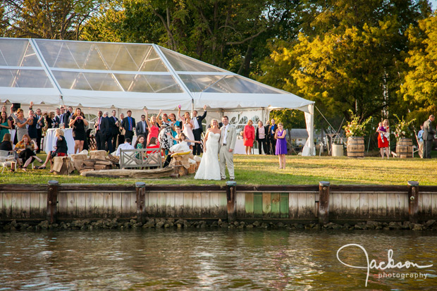 bride and groom by the water at reception