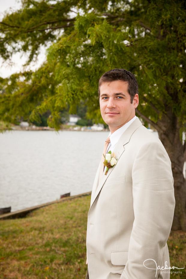 portrait of groom by the water