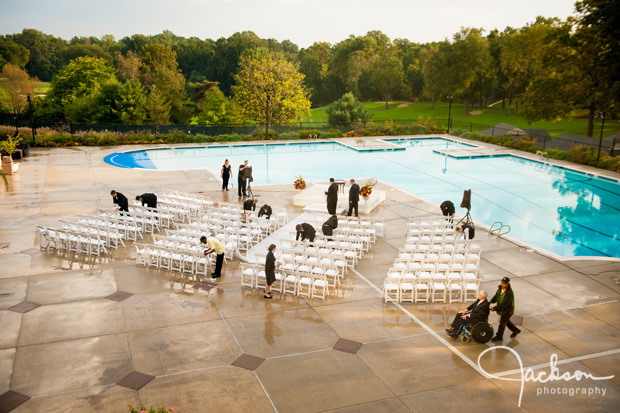 staff wiping down wet wedding ceremony chairs