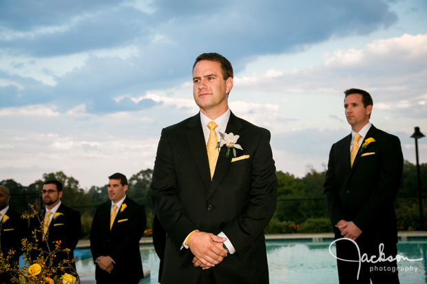 groom awaiting bride with storm clouds behind him