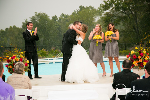 bride and groom kissing in the rain