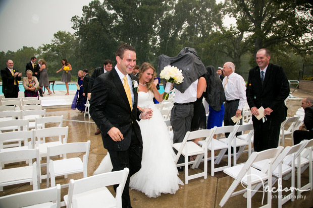 bride and groom leaving ceremony in the rain