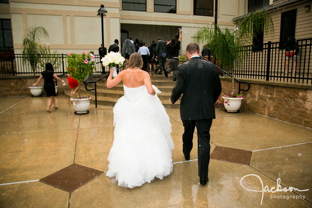 bride leaving ceremony in the rain