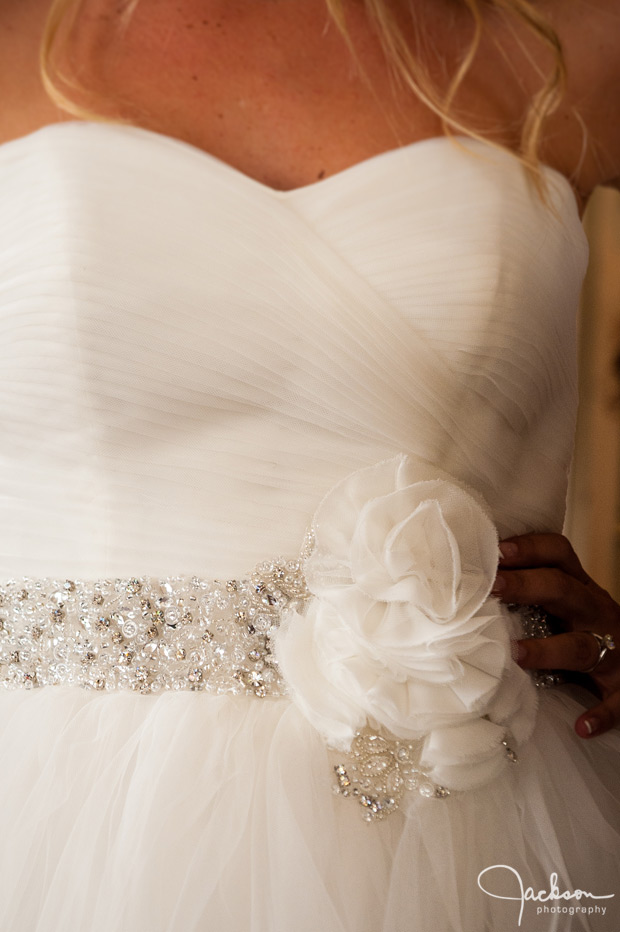 detail of beaded flower on bride