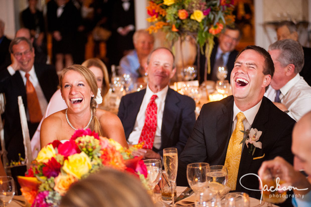 bride and groom laughing at toast