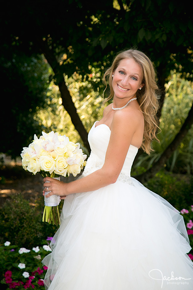 bride posing with cream and yellow bouquet