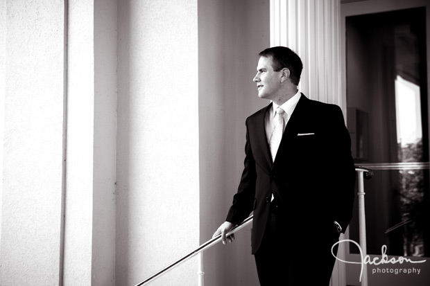 groom leaning on railing