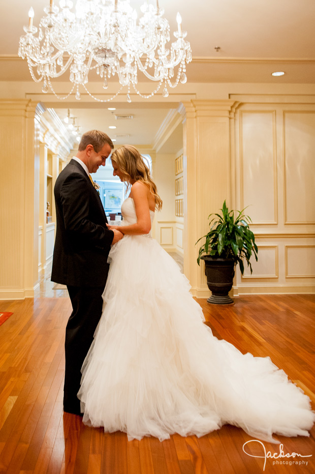 bride and groom beneath crystal chandelier