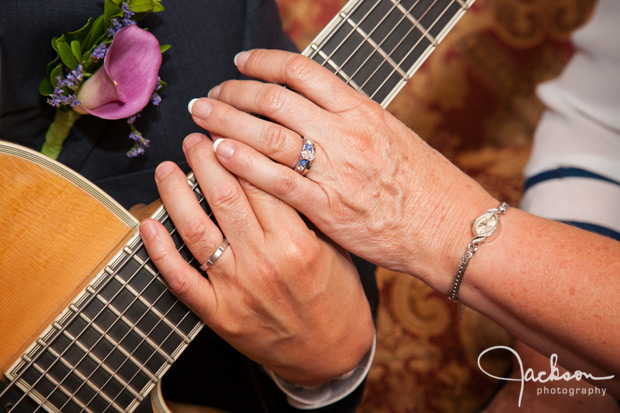 bride and groom's hands on guitar