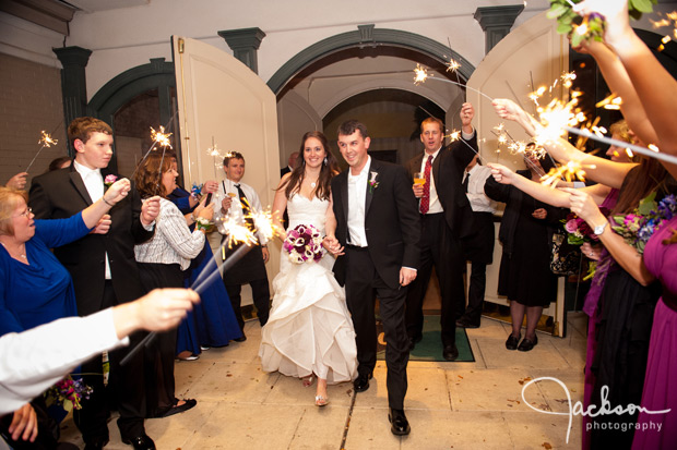 bride and groom leaving reception with sparklers