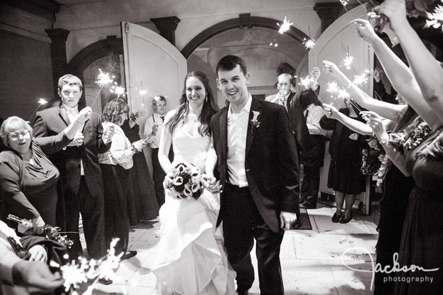 bride and groom leaving reception with sparklers