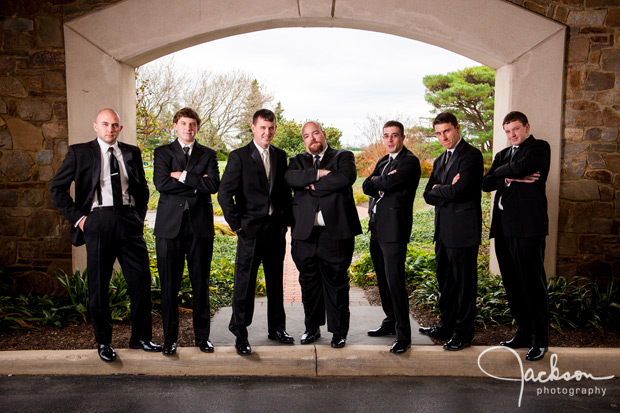 groom and groomsmen under archway