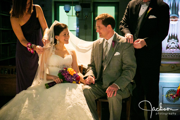 placing beads over bride and groom