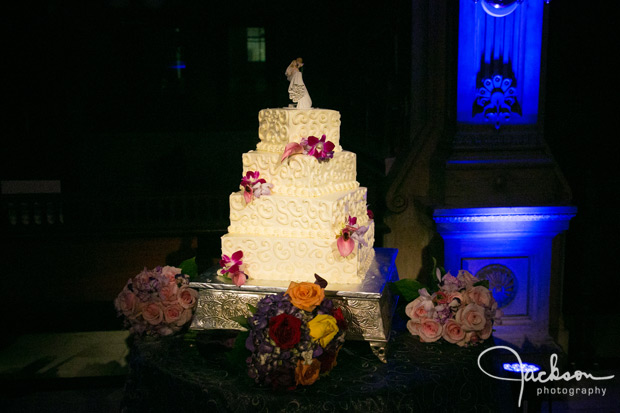 swirled square wedding cake with purple orchids