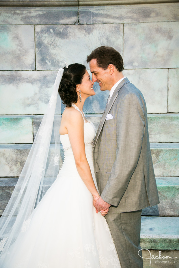 bride and groom close with marble background