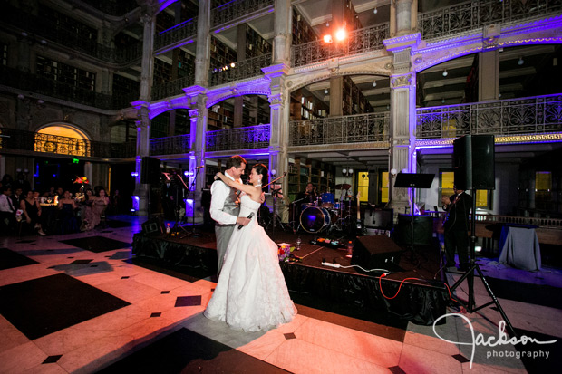 bride and groom on dancefloor lit by purple lights