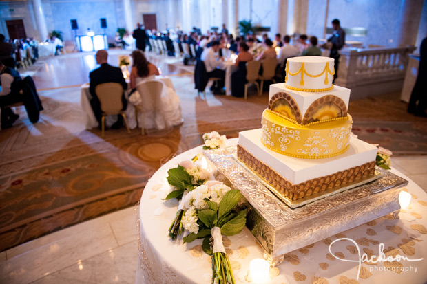 square gold and white ornate wedding cake
