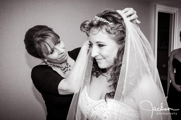 mother putting bride's veil on