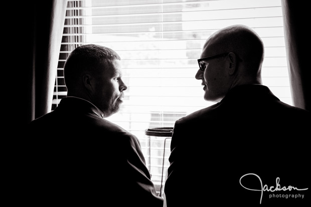 groom and groomsman looking out window