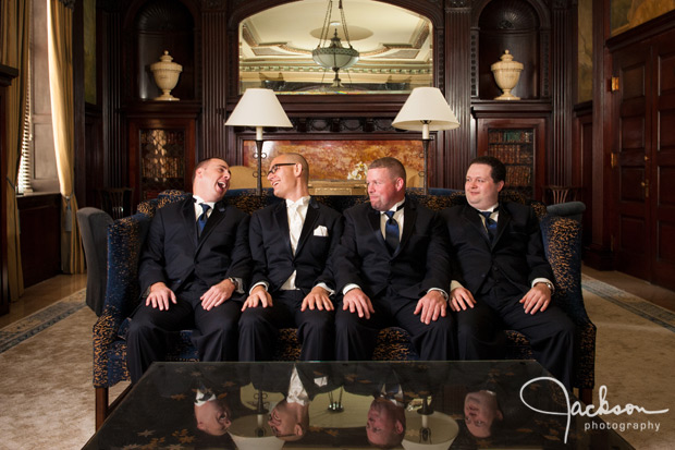 groom and groomsmen in wood paneled office