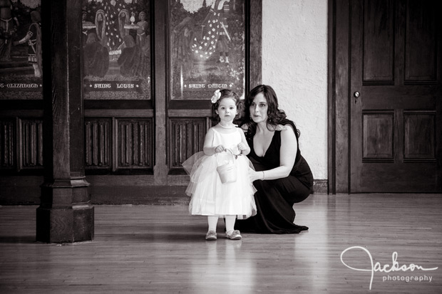 flower girl being coaxed down the aisle