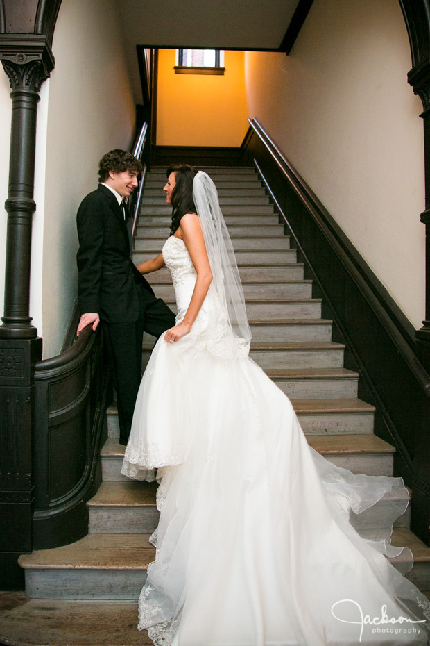 bride and groom in tall stairway