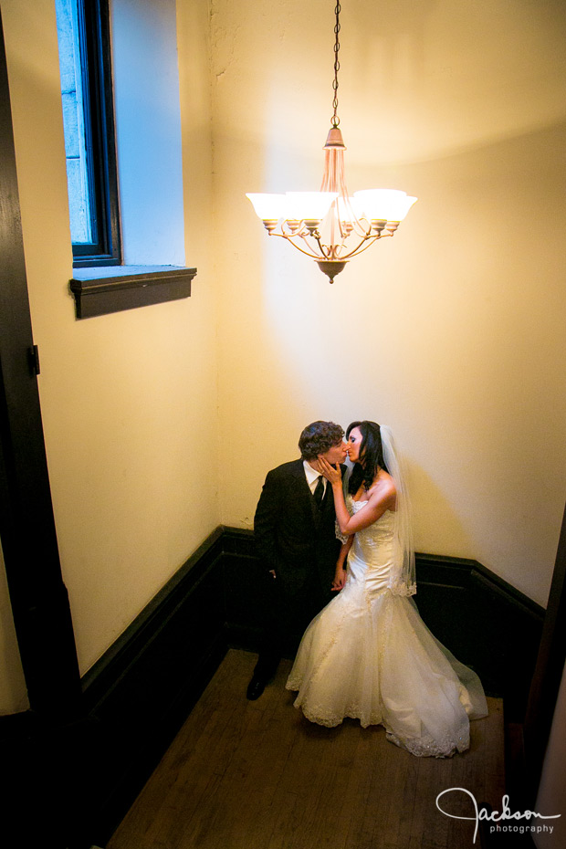 bride and groom under chandelier 