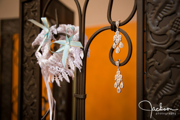 earrings and garter on iron railing