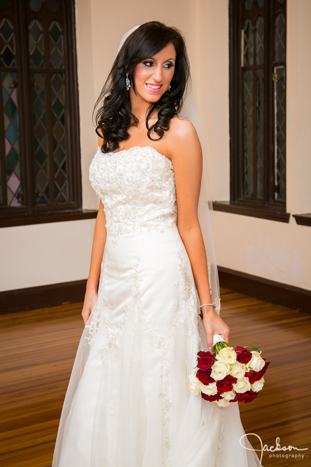 portrait of bride with white and red roses